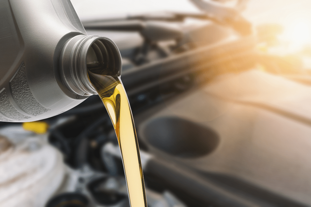 Oil change, auto repair in Bennington, NE by Accelerated Diagnostic and Automotive. Image of fresh engine oil being poured into the engine bay. Highlighting proper lubrication, extended engine life, and reliable vehicle performance.