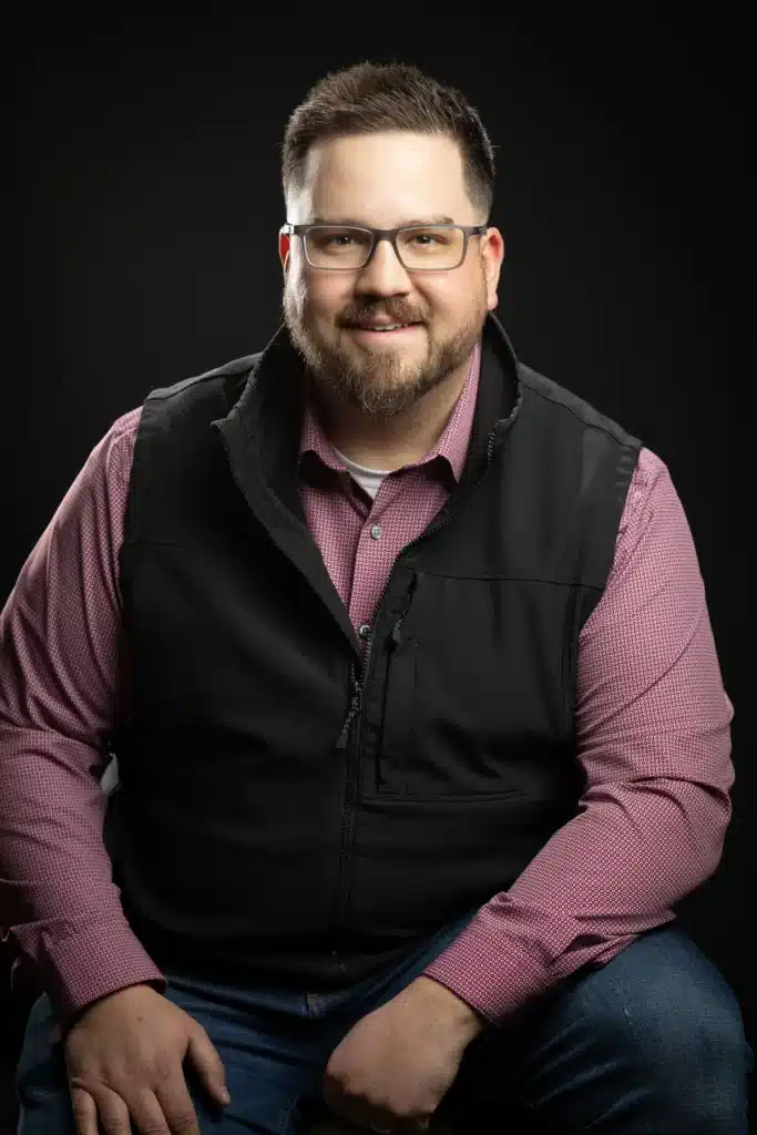 Matt Sell, General Manager at Accelerated Automotive, studio portrait wearing glasses and business casual attire.